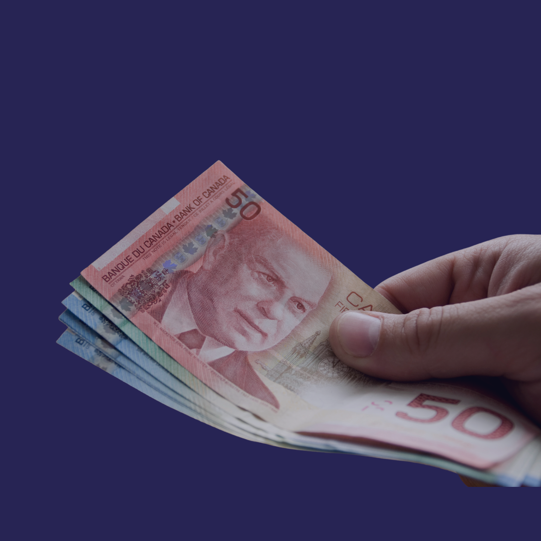 A close up hand with Canadian cash