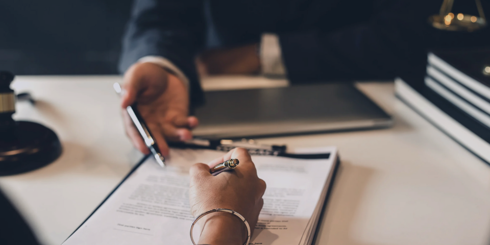 A close up of two hands reviewing a document.